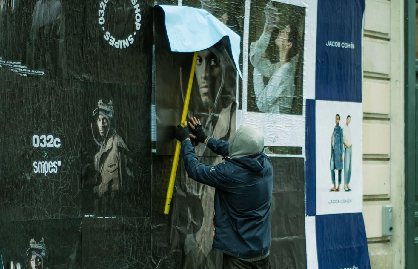 Wheatpaste poster installation by street teams in Toronto